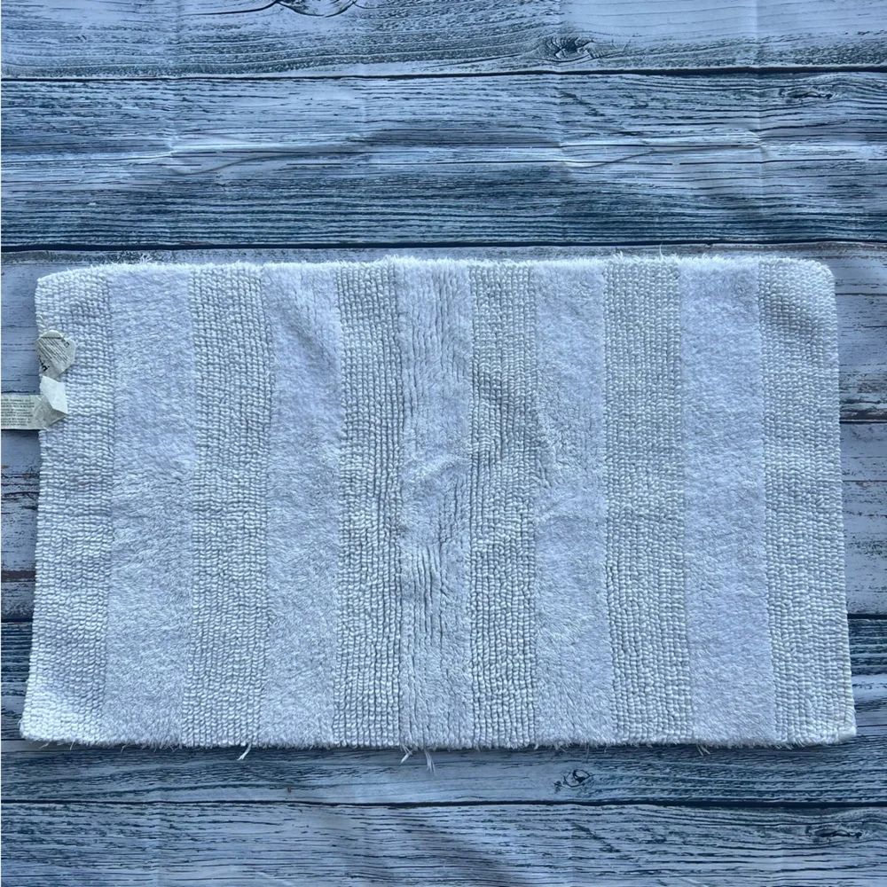 DKNY white bathroom rug 33in x 19in EUC